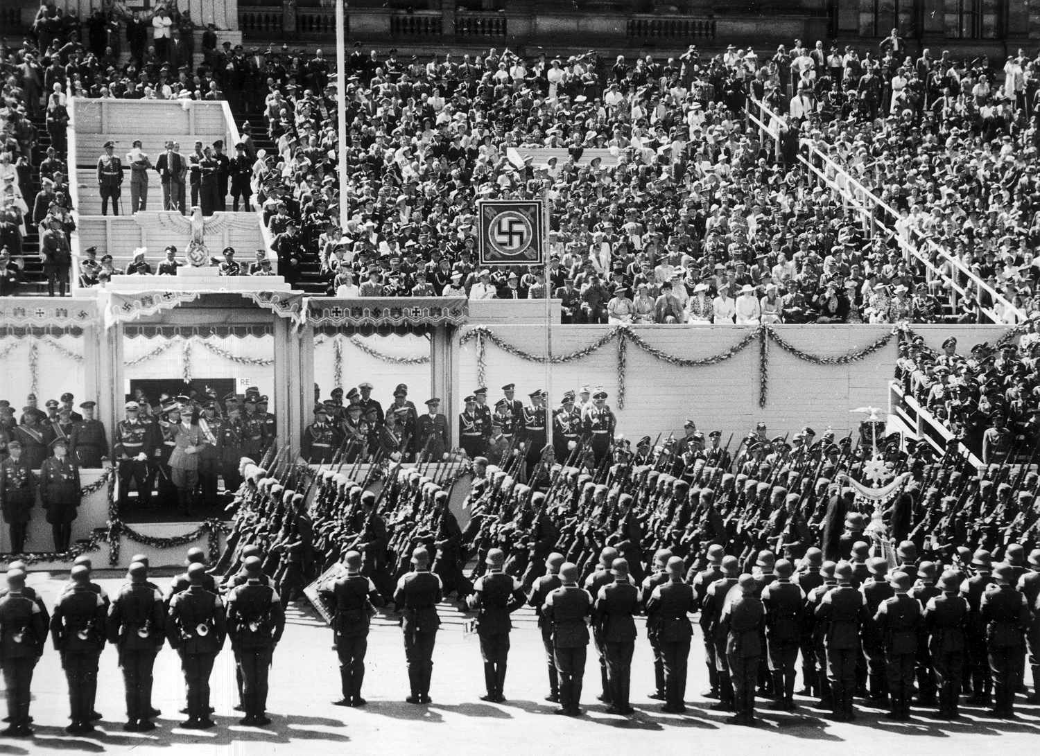 Parade of the Legion Condor in front of Berlin's Technische Hochschule in Charlottenburg, Adolf Hitler is in the tribune with officials and guests